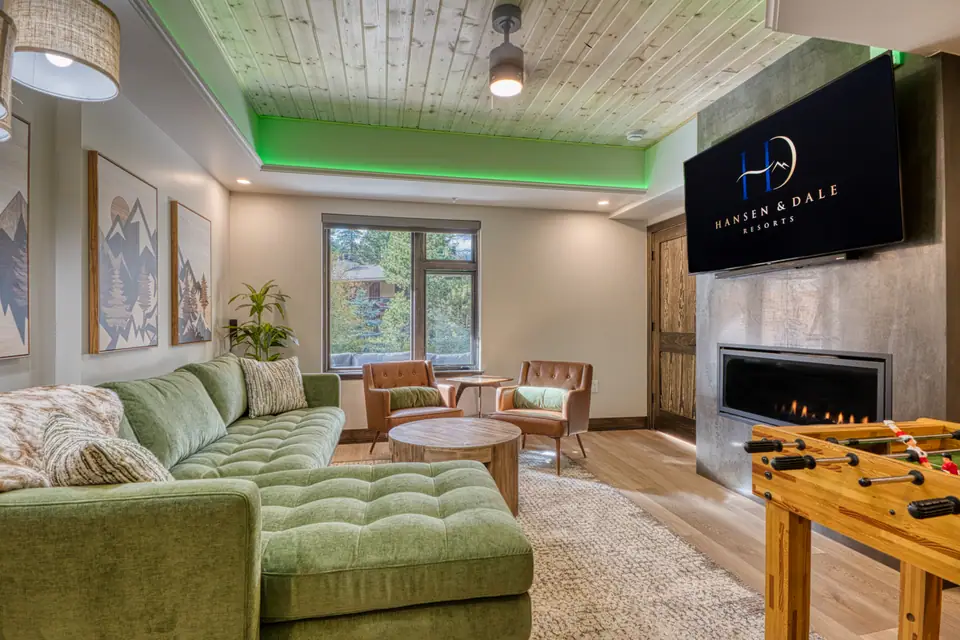 DreamView Grand living room with a fireplace and foosball table